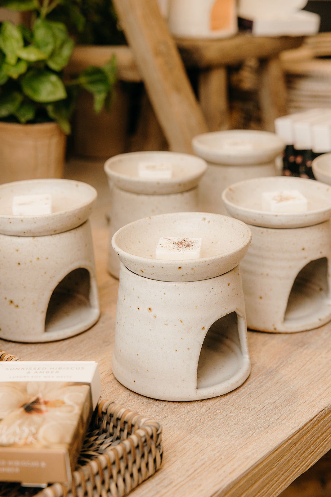 A collection of hand thrown wax melt oil burners in a shop setting, specifically Wild Nest Cotswolds based in Chipping Campden.