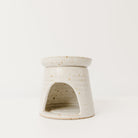 Speckled ceramic oil burner on a white background