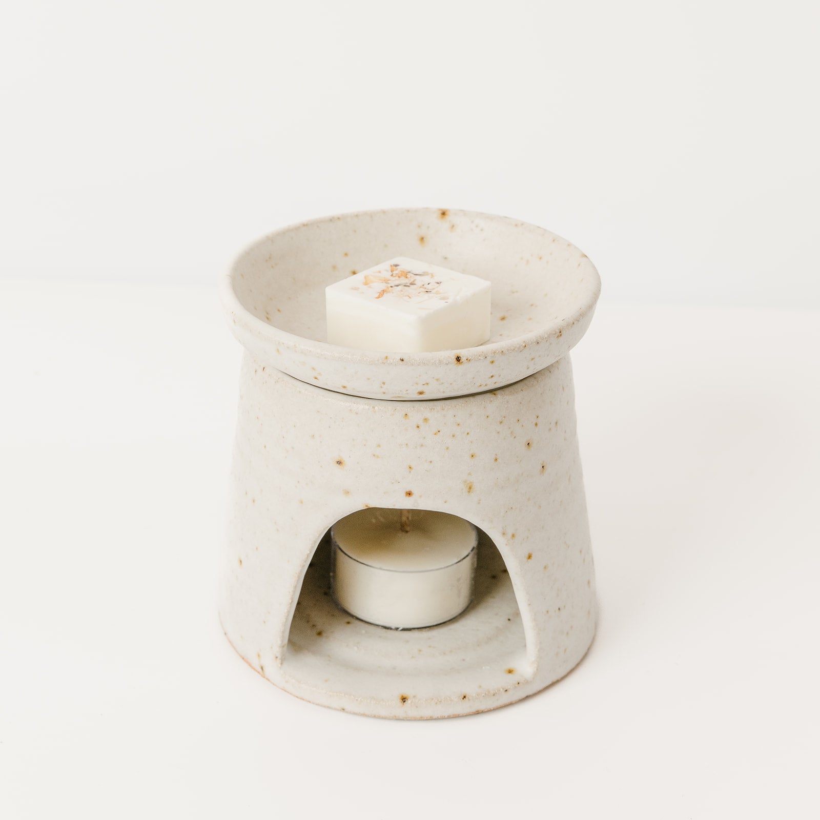 Ceramic oil burner with a small candle inside on a white background Wild Nest 