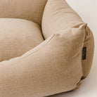A close up of a cotton linen dog bed, made from luxurious upholstery fabric