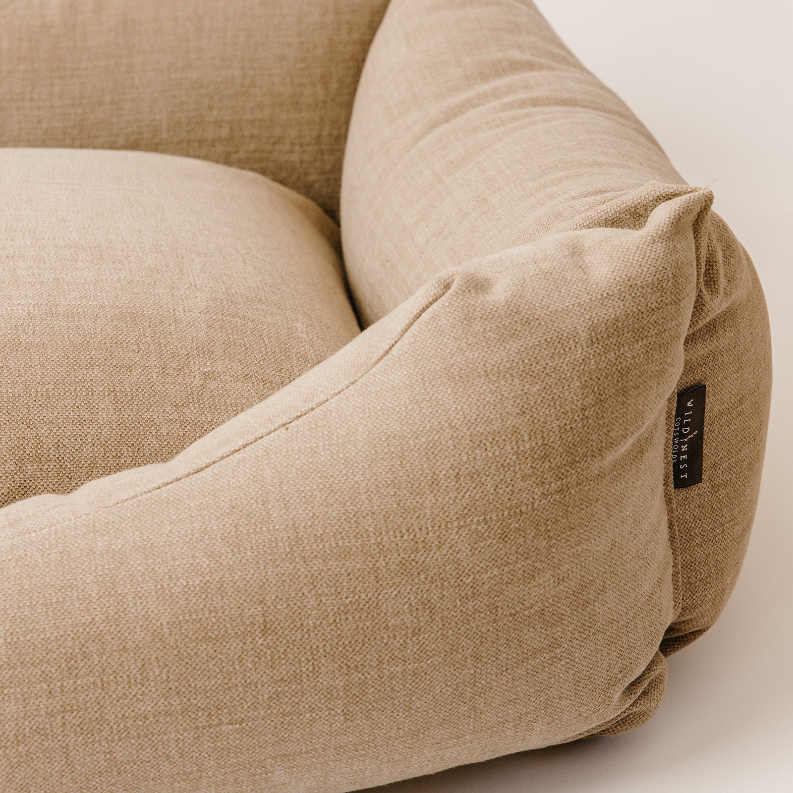 A close up of a cotton linen dog bed, made from luxurious upholstery fabric