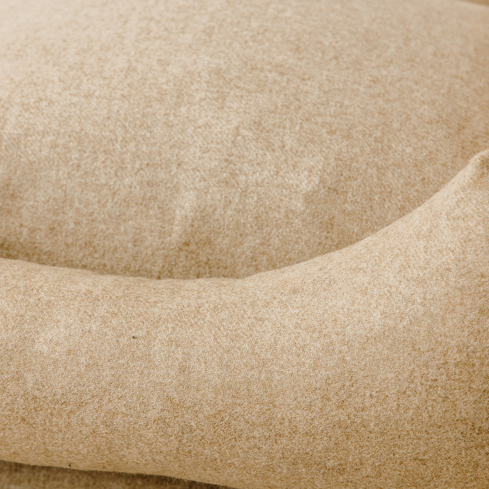 Close up view of wild nest Cotswolds handmade wool dog bed beige wool 